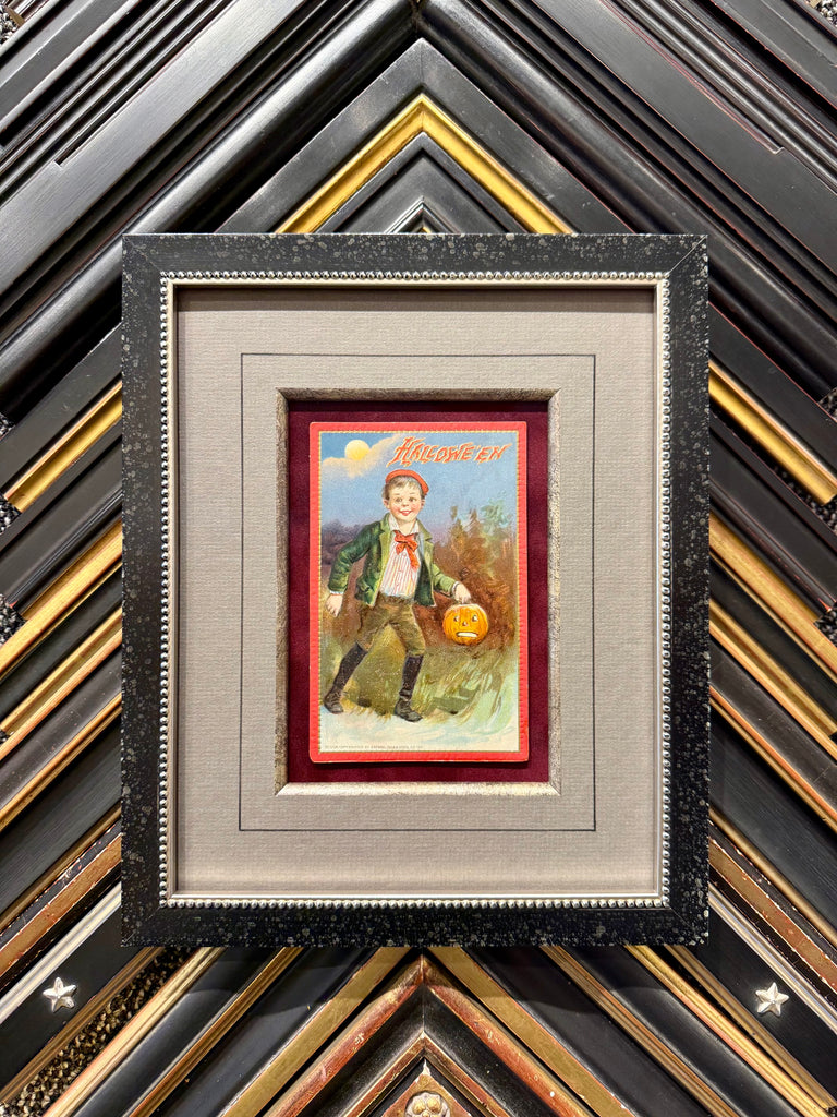 Framed antique Halloween postcard featuring vintage holiday imagery in a decorative frame.