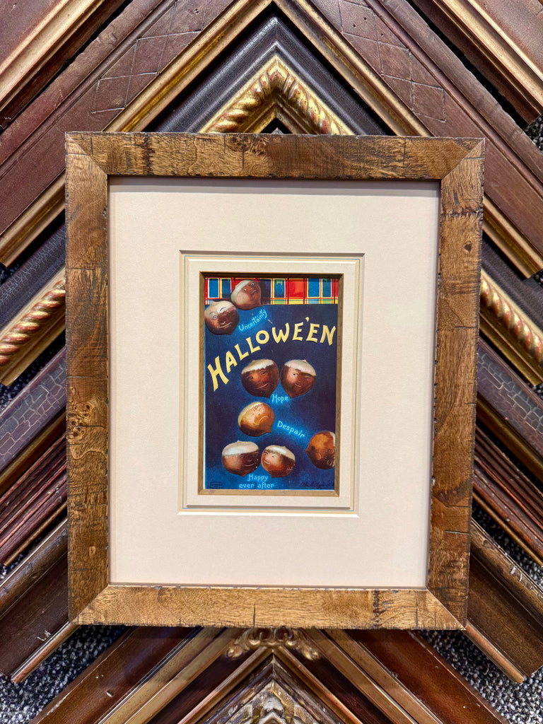 Framed antique Halloween postcard featuring vintage holiday imagery in a decorative frame.