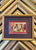 Framed antique Halloween postcard featuring vintage holiday imagery in a decorative frame.